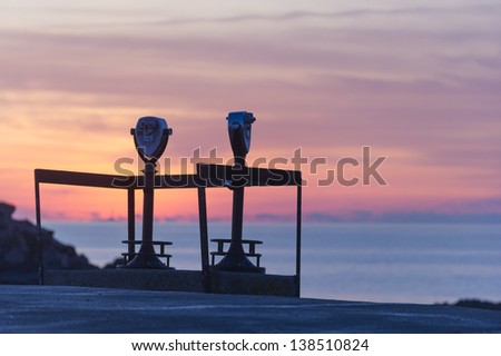 Pay binoculars at sunrise on Cape Neddick, York, Maine, USA