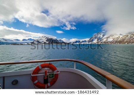HORNSUND, SVALBARD, NORWAY - JULY 26,  2010: Looking out from the bow of the National Geographic Explorer cruise ship while in the Arctic Ocean near Hornsund, Norway.