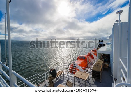 HORNSUND, SVALBARD, NORWAY - JULY 26, 2010:  Photographer on the National Geographic Explorer cruise ship in the Arctic.