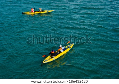 HORNSUND, SVALBARD, NORWAY - JULY 26,  2010:  Tourists in inflatable ocean kayaks, Hornsund, Norway