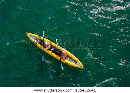 HORNSUND, SVALBARD, NORWAY - JULY 26,  2010:  Tourists in inflatable ocean kayaks, Hornsund, Norway