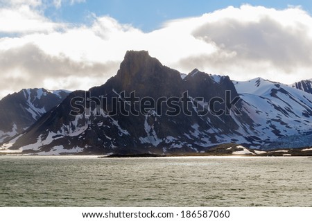 Glacier heading down from a mountain range into the Arctic Ocean, Hornsund, Norway
