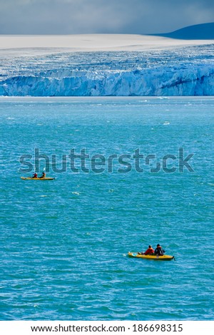 Tourists in inflatable ocean kayaks in the Arctic Ocean, Hornsund, Norway