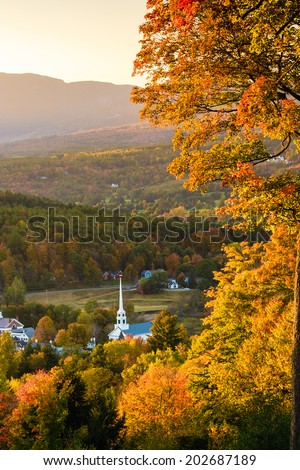 Overlooking a peaceful New England community church and village in an autumn sunset, Stowe, Vermont, USA