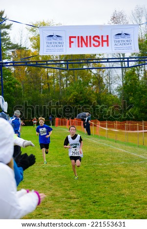 THETFORD CENTER, VT, USA - OCTOBER 4, 2014: Middle school boys running the 24th annual Thetford Academy Woods Trail Run, middle school boys division, finish line.