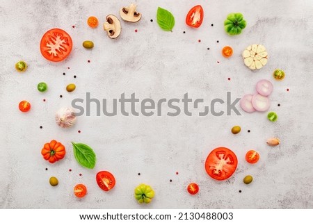 The ingredients for homemade pizza set up on white concrete background. Foto d'archivio © 