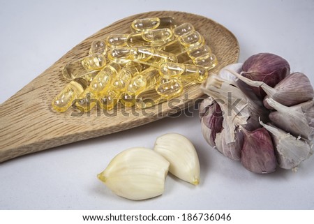 Capsules of garlic oil in a bucket of wood
