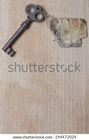 Antique Key with Label on Wood