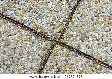 exposed aggregate concrete with dirty gaps