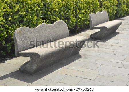 stone benches along a hedge