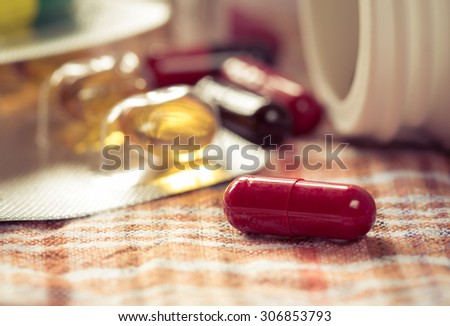 medicine capsule on check fabric
