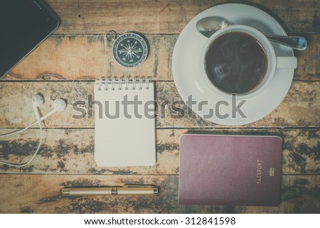 travel equipment and coffee on grunge wood