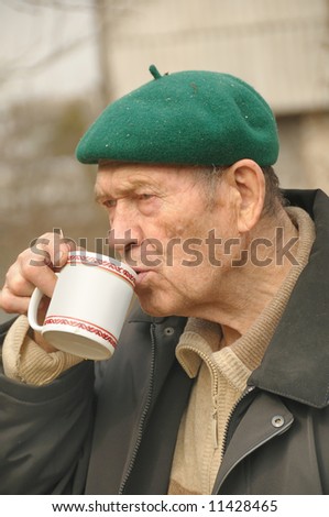 an old men drinking tea