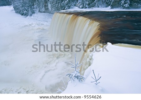 Winter, Upper Tahquamenon Falls framed by ice and snow, Michigan\'s Upper Peninsula, USA