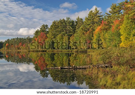 Autumn, Big Twin Lake with reflections of clouds and colorful foliage, Michigan\'s Upper Peninsula, USA