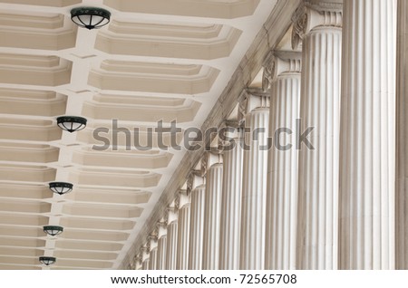 Classic, fluted stone architectural columns, ceiling, and light fixtures