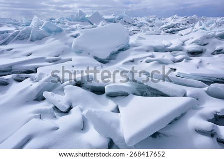 Landscape of blue ice shards and snow covered shoreline of Lake Michigan, Sleeping Bear Dunes, Michigan, USA
