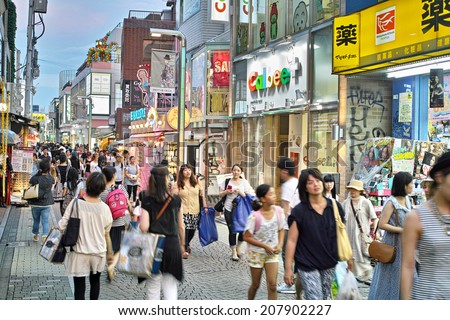 HARAJUKU, TOKYO - JULY 26, 2014: Takeshita Street, pedestrian street with many fashion boutiques, groceries, restaurants and cafes. Takeshita Dori is very popular among younger generations.