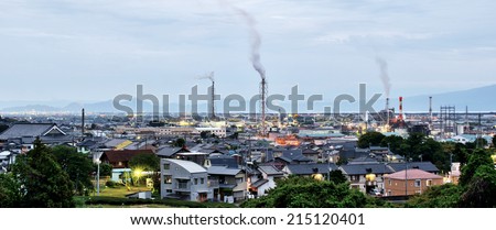 SHIZUOKA, JAPAN - MAY 19, 2013: Fumes and chimneys of paper mills in Fuji City, Shizuoka. Paper manufacturing is the main industry of Fuji City.