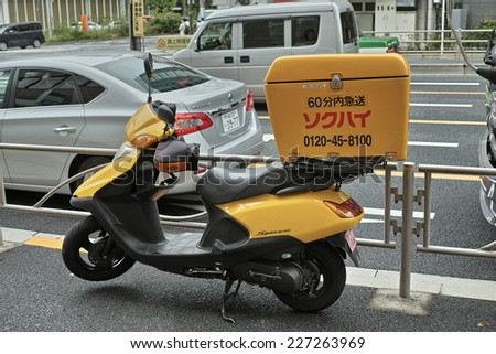 GOTANDA, TOKYO - AUGUST 23, 2014: Sokuhai express delivery motorbike. Motorcycle courier service is popular for business use in Japan, especially in Tokyo. Sokuhai is one of the biggest transporter.