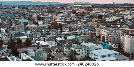 CHOFU, TOKYO - DECEMBER 7, 2014: Central area of Chofu City, western part of Tokyo. Commercial and residential buildings stand side by side, it is a typical urban development style of Japanese town.