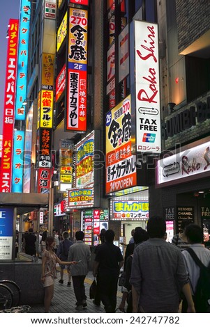 SHINJUKU, TOKYO - MAY 31, 2014: Street view of Shinjuku commercial district at night. Many neon sign billboards along the commercial buildings. Shinjuku is one of the biggest & busiest town in Japan.