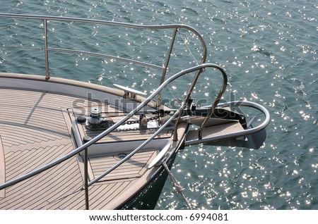Sail boat bow against sparkling blue water