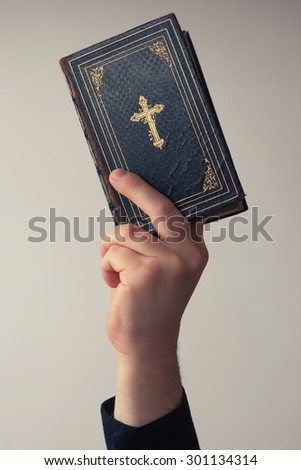 Man is holding the Bible in the Air