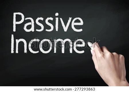 Hand writing passive income with white chalk