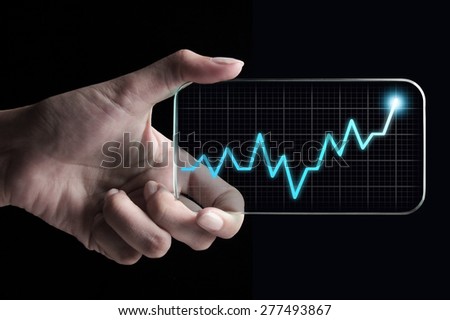 Hand showing a rising graph on tablet, representing business growth. The background is black, chart colors are white and blue.
