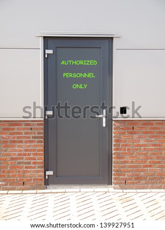 metal door with text authorized personnel only and access control system