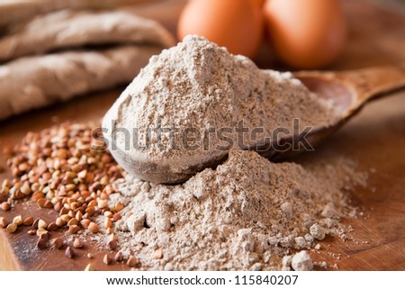 Buckwheat flour in a wooden measuring spoon
