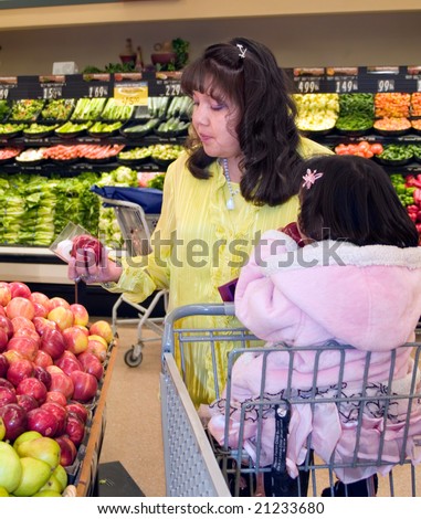 Native American woman shopping in the produce department of a grocery store