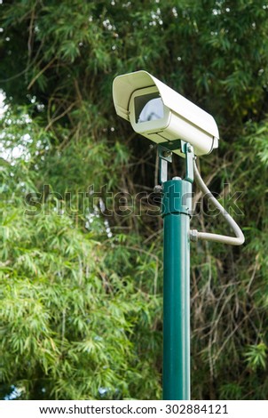 CCTV camera on green pole stand in the park for outdoor security