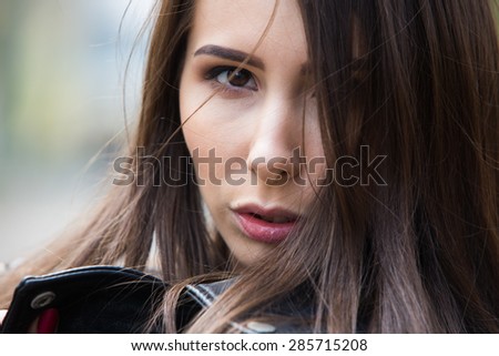 Portrait of a girl in the street close up