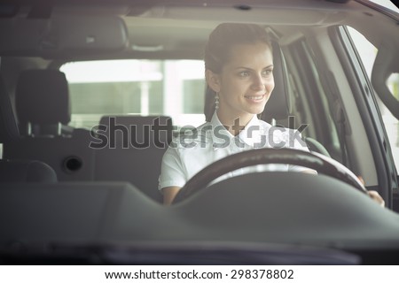 attractive young woman driving a car