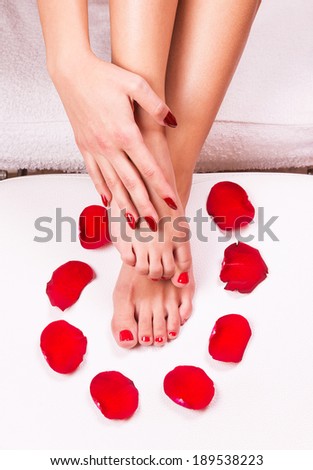 Spa background with a beautiful legs, flowers, petals.