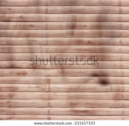 Bamboo sticks wooden background with thread uniting and stains