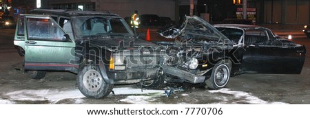 Two cars which were involved in a collision rest at an intersection.