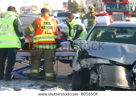 A woman is cared for by emergency workers after a motor vehicle accident in Edmonton,Alberta,Canada.
