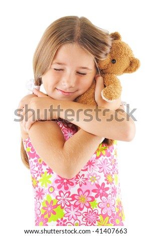 Little girl hugging bear toy. On white background