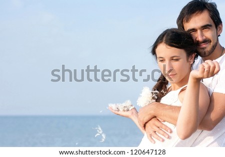 Young couple at beach, falling in love, side view. Banner, lots