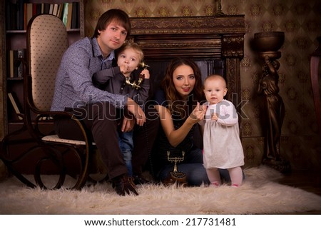 a family on a fluffy carpet by the fireplace