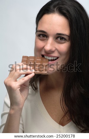 Young woman with a brick of chocolate isolated on white background