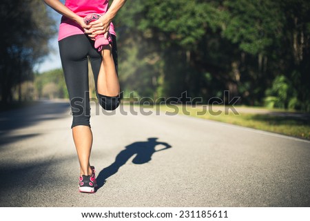 Woman is stretching before jogging. Fitness and lifestyle concept.