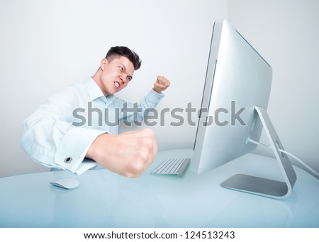 A furious businessman frustrated with his lack of wireless connection and or computer skills takes his anger out by punching his computer