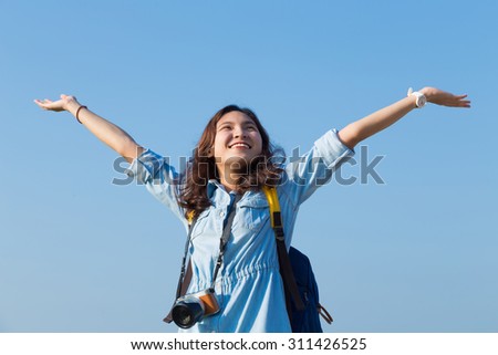 asian woman happy smile and put her hand in the air