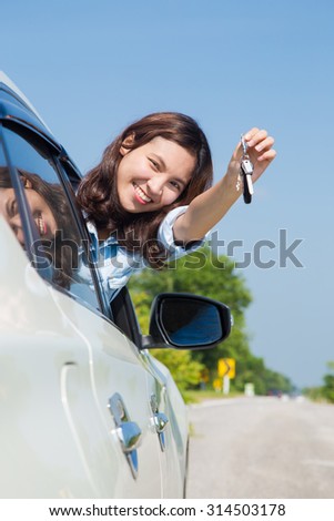 Asian woman, Young female driving happy about her new car or drivers license