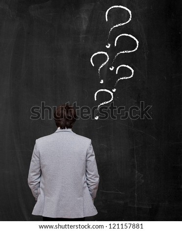 businssman decision making at chalkboard