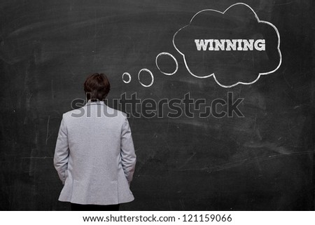 businessman think about winning at chalkboard